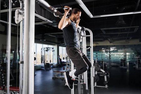 An athletic man in active wear is conquering pull ups with determination and strength in a gym setting.
