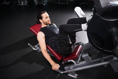 Photo for A fit man in athletic wear sitting contemplatively while weightlifting in a gym. - Royalty Free Image