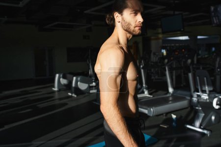 A shirtless, muscular man stands confidently in front of a line of treadmills, ready for a powerful workout session.