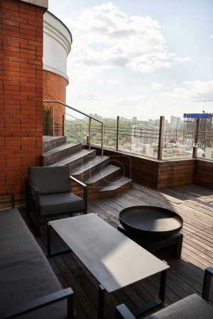 A balcony overlooking the city with a table and chairs set up, inviting relaxation and enjoyment of the urban view