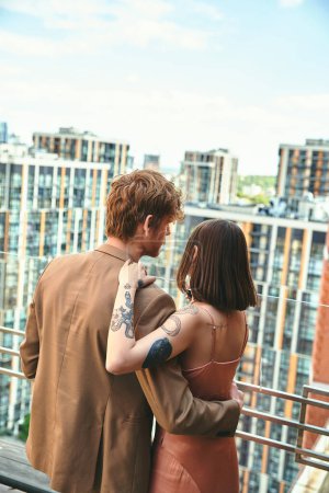 A man and a woman standing together on a balcony, enjoying the view and each others company on a peaceful afternoon