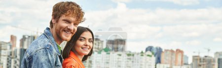 Photo for A man and a woman stand before a sprawling city skyline, gazing out at the towering buildings in awe and wonder - Royalty Free Image