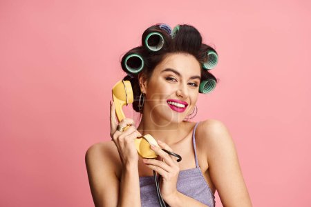Alluring woman gracefully holding retro phone.