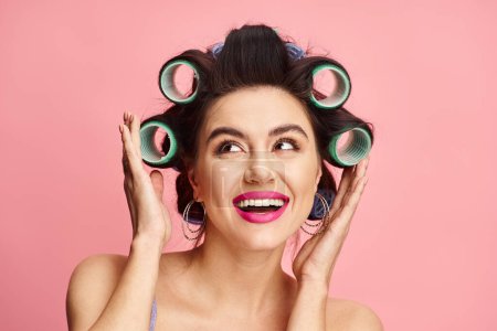 Woman with curlers, holding her hair.