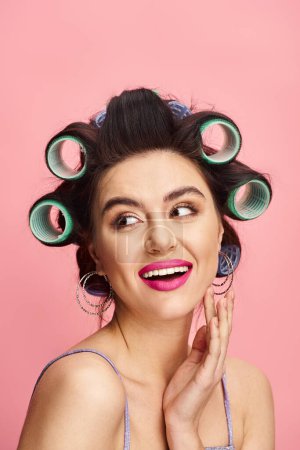 Stylish woman showcasing a beauty routine with hair curlers in her hair.