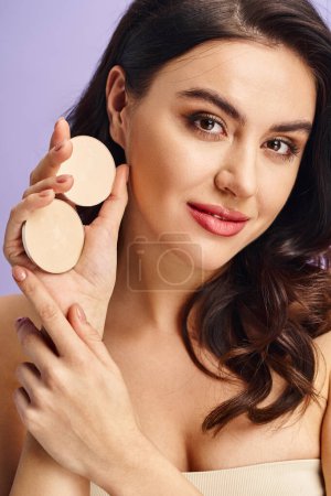 A stunning woman with natural beauty applying makeup using a compact.
