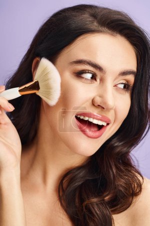 A woman gracefully brushes her face with a makeup brush.