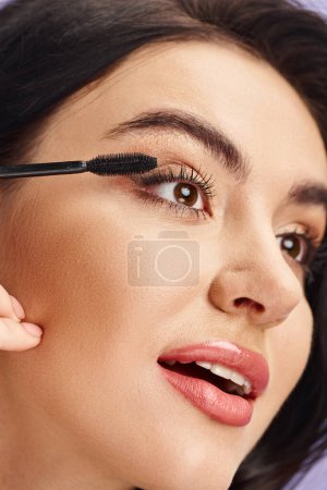 A woman with natural beauty applies mascara to her lashes.