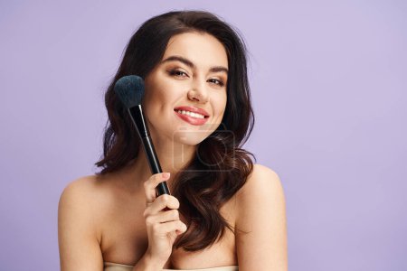 A woman delicately holds a makeup brush in her hand, enhancing her natural beauty.