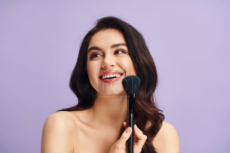 A woman with natural beauty delicately holds a makeup brush in her hand.