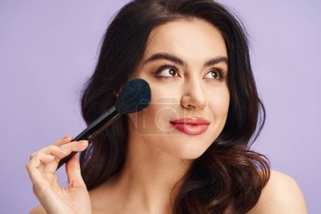 A woman with natural beauty delicately holds a brush to her face.