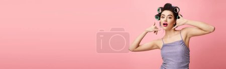 Photo for A woman in a tank top with curlers. - Royalty Free Image