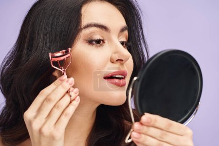 Woman with eyelash curler gazes into mirror.