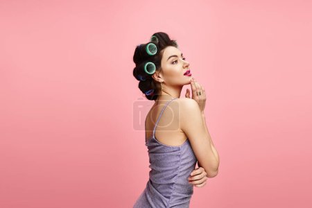 A stunning woman in a purple dress with green hair rollers, showcasing her natural beauty.