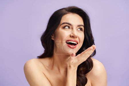 Photo for A woman with natural beauty, with makeup, makes funny faces with her hands. - Royalty Free Image