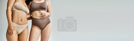 Photo for Two diverse women in cozy pastel underwear standing together. - Royalty Free Image