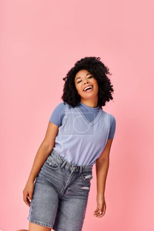 Photo for A stylish woman in a blue shirt and denim shorts exudes confidence and elegance. - Royalty Free Image