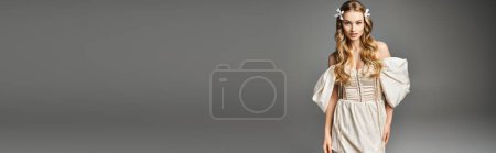Photo for A young blonde woman exudes grace and elegance as she stands in a white dress in a studio setting. - Royalty Free Image