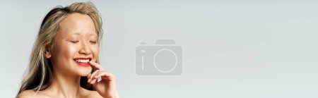 Photo for An attractive Asian woman smiles while posing. - Royalty Free Image