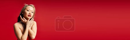 Photo for Asian woman in a vibrant red dress posing actively. - Royalty Free Image