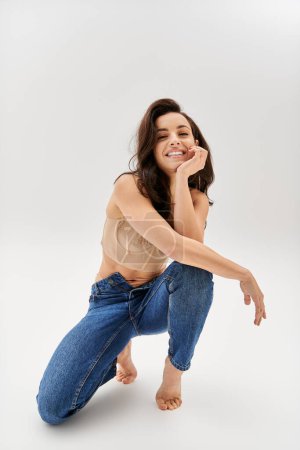 Stylish woman confidently poses in denim jeans, exuding charm.