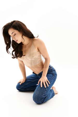 Photo for A woman kneeling while elegantly putting her hands in her pockets. - Royalty Free Image