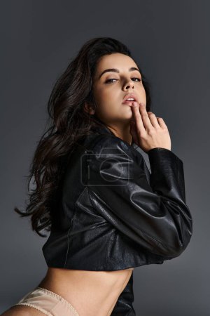 Young woman striking a pose in a leather jacket.