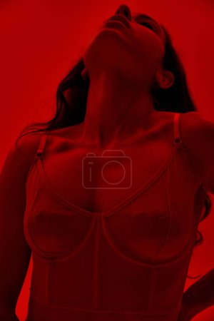 Photo for A captivating woman in a lingerie gazes up at the sky with intrigue. - Royalty Free Image