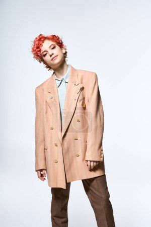 Extraordinary woman with red hair dons a refined tan suit.