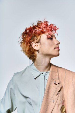 A woman with red hair exudes elegance in a fashionable jacket.