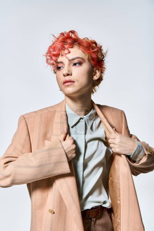 A striking woman with red hair dons a stylish jacket.