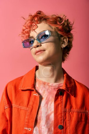 A young woman with red hair exudes style in sunglasses.