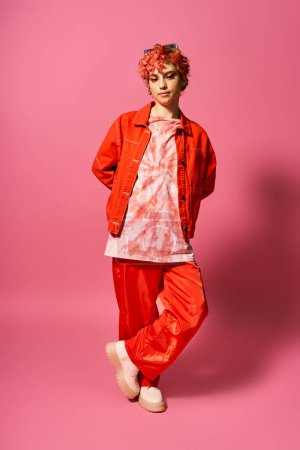 A striking woman dons a vibrant red jacket and matching pants.