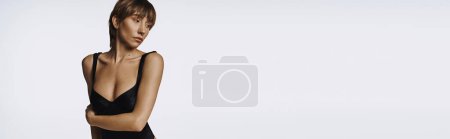 Téléchargez les photos : Femme élégante en maillot de bain noir frappant une pose. - en image libre de droit