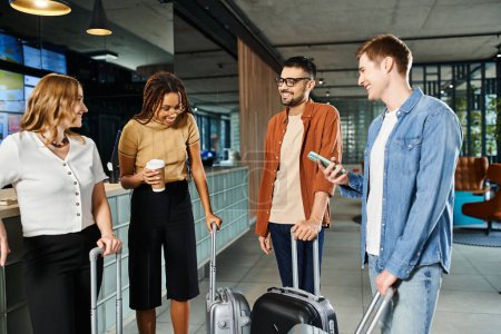 Diverse group of businesspeople in casual attire standing together with luggage in a hotel lobby during a corporate trip.