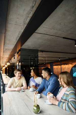 Colleagues from a startup team gather around a table in a restaurant, engaged in a lively brainstorming session.