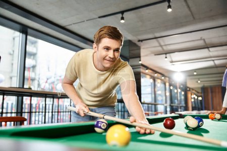 Two colleagues from a startup team enjoy a game of pool in a spacious room, immersed in friendly competition and relaxation.