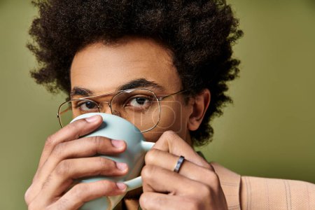 Photo for A sophisticated man with glasses enjoying a cup of coffee. - Royalty Free Image