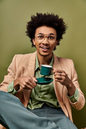 Photo for Stylish African American man in suit and sunglasses holding a cup of coffee against a vibrant green background. - Royalty Free Image
