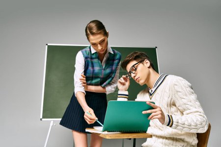 Photo for Elegant male and female students sitting in front of a green board in a college setting. - Royalty Free Image