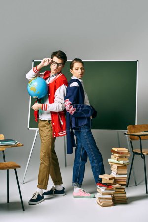 Male and female students in casual clothes standing before green board in college classroom