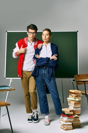 Photo for Male and female students pose confidently in front of a green board. - Royalty Free Image