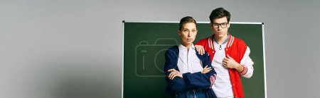 Photo for Two students stand together in a college classroom, showcasing camaraderie and academic support. - Royalty Free Image