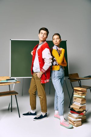 Photo for Two stylish college students pose in front of a green board, exuding confidence and intellect. - Royalty Free Image