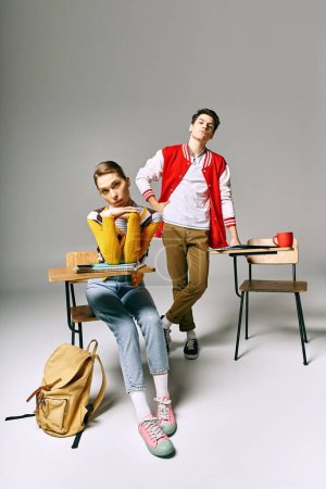 Attractive male and female students posing casually in a college classroom.