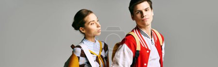 Téléchargez les photos : A stylish male and female students stand confidently in a college classroom. - en image libre de droit
