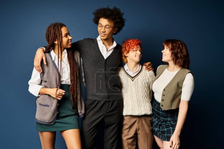 Multicultural friends, stand together in stylish attire on a dark blue background.
