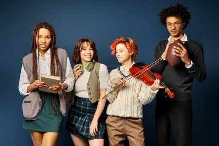 A group of multicultural young friends, stand together in stylish attire on a dark blue background.