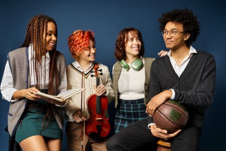 A group of young multicultural friends, including a nonbinary person, standing in stylish attire on a dark blue background.
