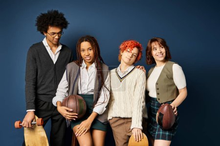 Multicultural group of young friends, standing together in stylish attire on dark blue background.